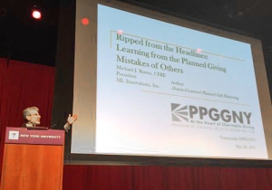 Michael Rosen at PPGGNY Conference, starting at the podium before speaking from the audience during his keynote address.